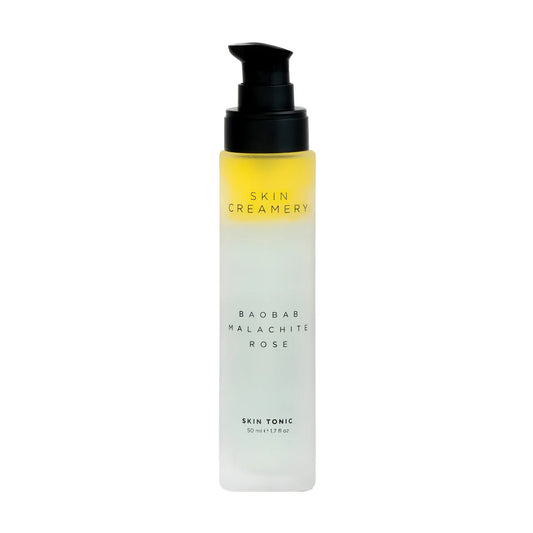 Skin Creamery toner and hydrator.  Yellow and green liquid in glass bottle with black pump lid  